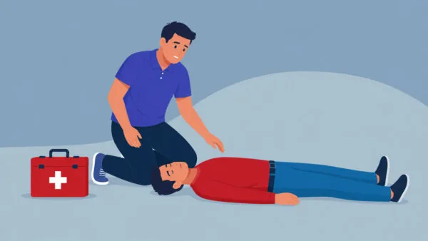 Kantoormedewerker zit naast een bewusteloos iemand